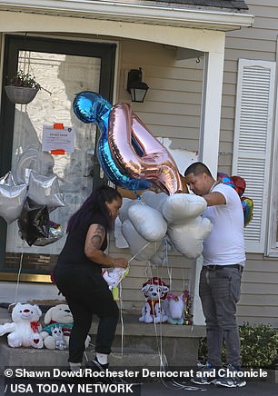 Family and friends gathered to honor the family with an impromptu vigil with balloons and stuffed animals outside their home on Knapp Avenue