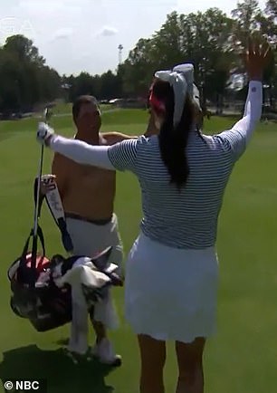 The caddies celebrated wildly after Alison Lee holed the ball