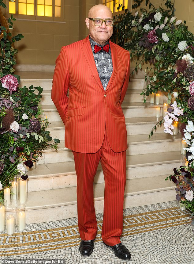 American actor Laurence Fishburne, 63, looked handsome in a blood orange suit which he wore with a black and white patterned shirt and a red bow tie