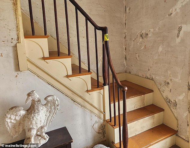 A grand staircase is one of the house's biggest attractions and features beautiful original woodwork, but still needs some restoration