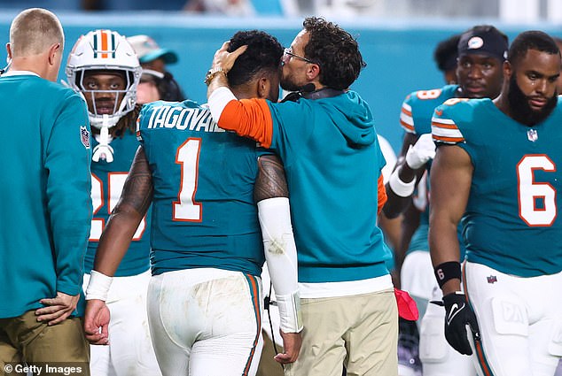 As the quarterback left the field, his coach Mike McDaniel gave him a kiss on the head