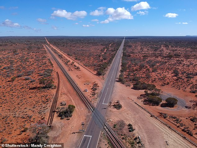 No serious injuries were reported among the train passengers (pictured one of the crossings of The Ghan with the Stuart Highway)