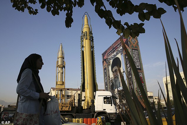 Pictured: A Ghadr-H missile (center), a solid-fuel Sejjil rocket and a portrait of Iranian Supreme Leader Ayatollah Ali Khamenei