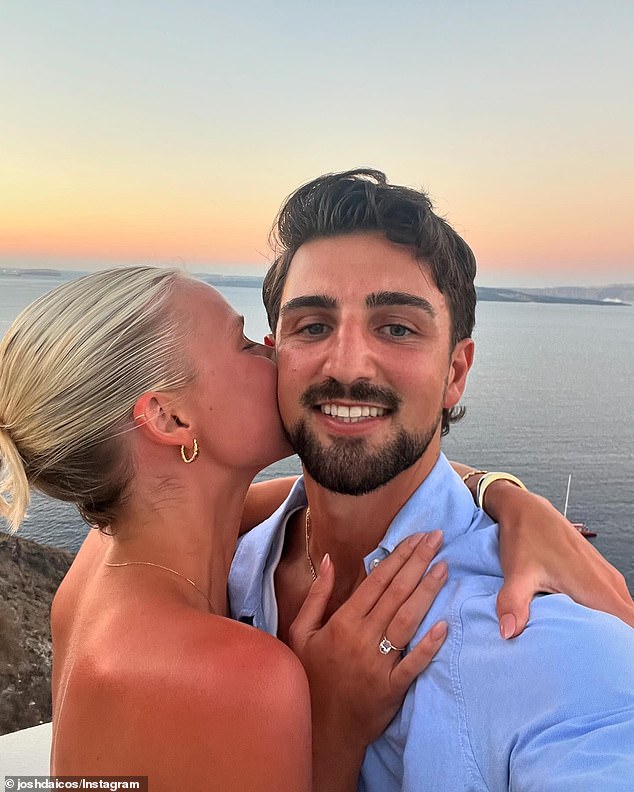 The couple cuddled up together under a beautiful sunset and a picturesque waterway. Model Annalise looked stunning in a sleeveless white dress and showed off her oval bling