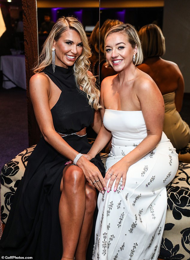 Christine McGuinness, 36, showed off her toned midriff in a glamorous black dress with cutouts as she made a stylish appearance for photos at the charity event