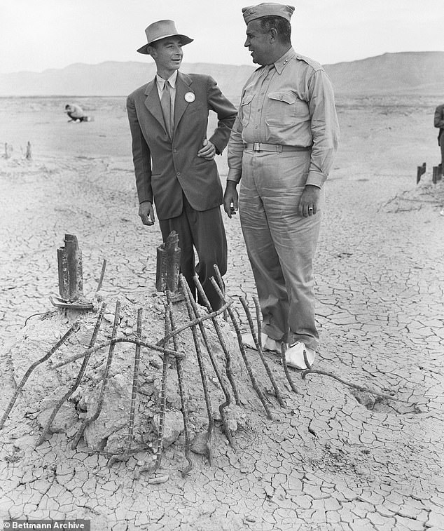 Major General Leslie Groves (right), head of the Manhattan Engineering District where the first atomic bomb was developed, and Dr. J.R. Oppenheimer, director of a top-secret project, discuss the secret program that led to the plutonium contamination that remains at the site today.