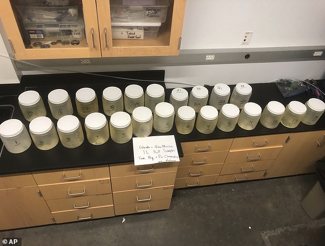 This July 22, 2024, image provided by biochemist Michael Ketterer shows jars containing water samples from Acid Canyon in Los Alamos, New Mexico