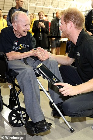 Prince Harry shakes hands with 102-year-old WWII veteran Norm Baker during the Invictus Games in Toronto in 2017