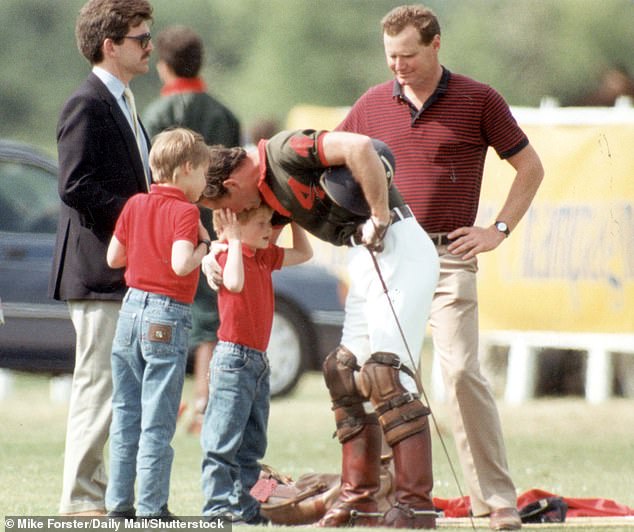 Prince Charles appears to speak sternly into his son's ear during a polo match in Cirencester, 1990