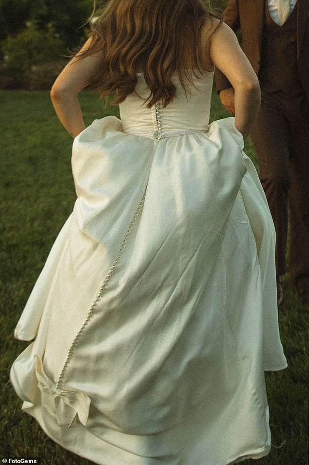 The pearl pin she placed on the front of the dress matched the buttons on the back of her vintage wedding dress