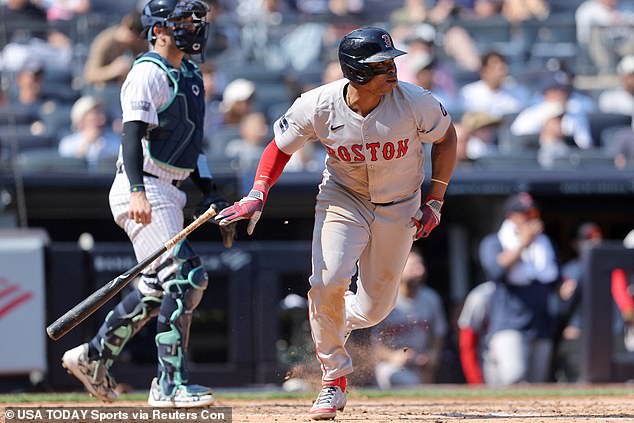 Boston Red Sox third baseman Rafael Devers (11) follows up with a two-run single