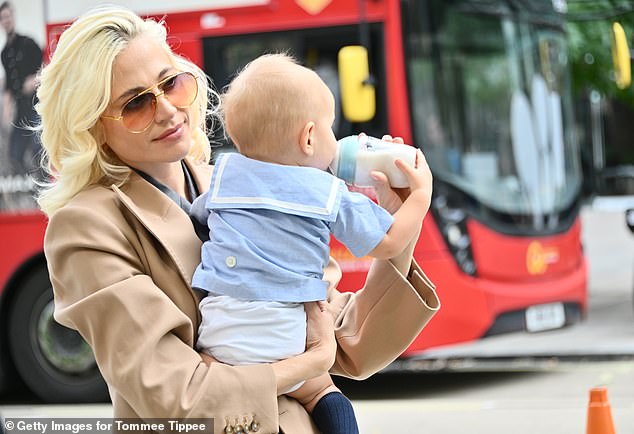 The hitmaker added a pair of patent leather loafers and oversized tinted aviator sunglasses as she sweetly held her little boy in her arms