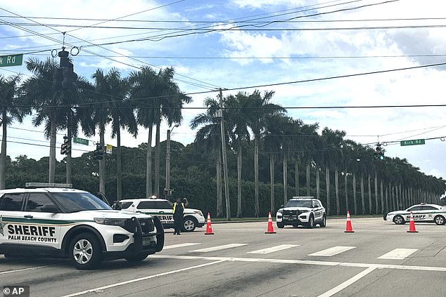 Palm Beach Sheriff's Department vehicles were lined up outside Trump International Golf Club on Sunday after gunfire was reported near where the former president was golfing.