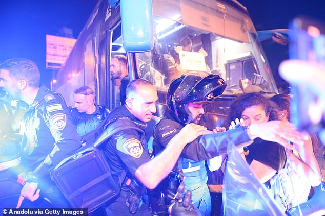 Israeli troops intervene as thousands of Israelis gather with banners and Israeli flags to protest Israeli Prime Minister Benjamin Netanyahu and his government for not signing the Gaza ceasefire agreement and to demand a hostage swap deal with Palestinians in Tel Aviv, Israel on September 14, 2024