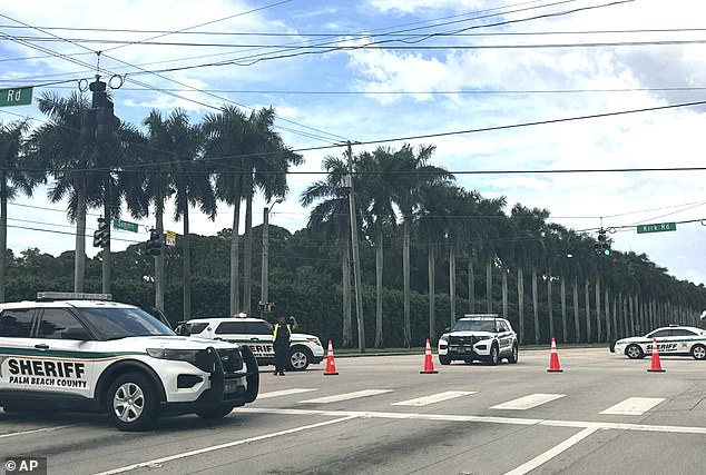 Palm Beach Sheriff's Department vehicles were lined up outside Trump International Golf Club on Sunday after gunfire was reported near where the former president was golfing.