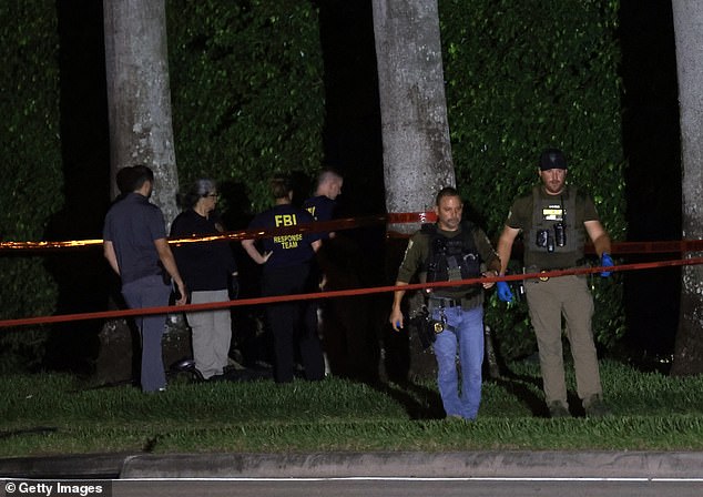 The terrifying threat to the former president was spotted by a Secret Service agent who saw something strange protruding from the fencing surrounding the golf course. (Photo: Police personnel investigate the crime scene Sunday night)