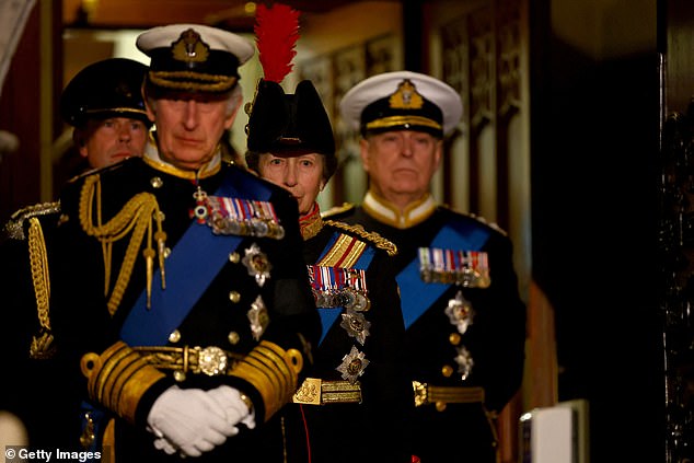 Charles wears a Navy admiral's uniform, while his siblings follow him, also in military uniform