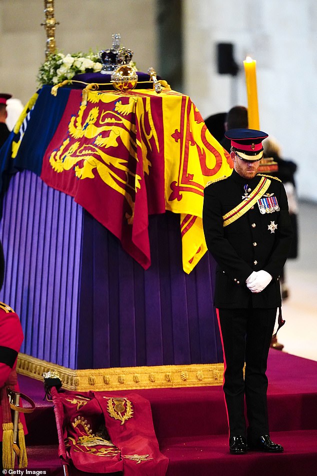 Prince Harry stands at the end of his late grandmother's coffin