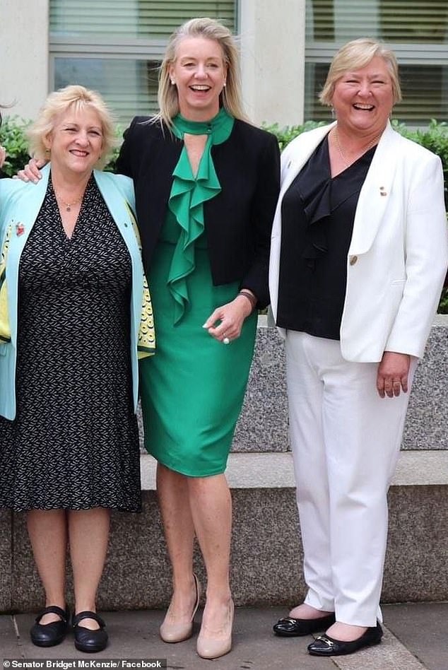 Ms. McKenzie used to wear skirts and dresses to work (pictured center), but she feels more comfortable in a suit