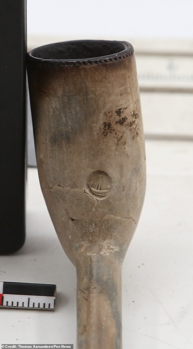 Photo shows a pipe with 'Cork' embossed on the side, recovered from the wreck