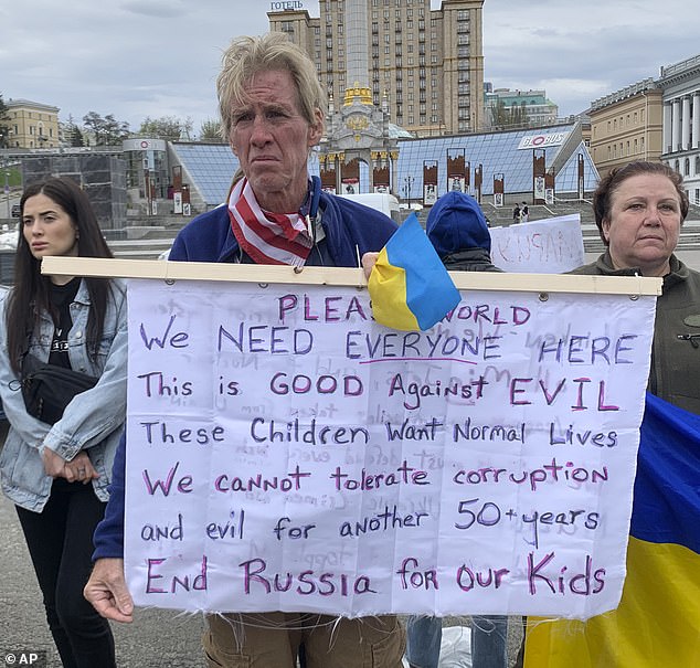 Ryan Wesley Routh holds a banner during a rally in downtown Kiev, Ukraine on Saturday, April 30, 2022