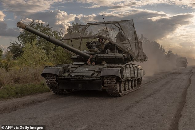 Ukrainian soldiers drive Soviet-made T-64 tanks in the Sumy region on August 11