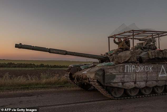 Ukrainian soldiers operate a tank on a road near the border with Russia, in the Sumy region of Ukraine, on August 14, 2024