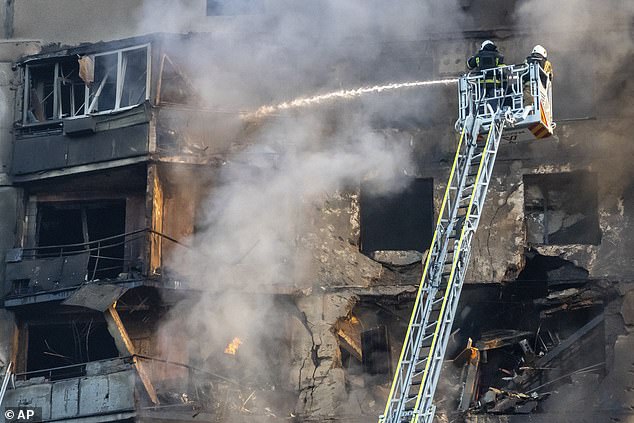 Photos taken at the scene show firefighters extinguishing flames from the upper portion of the building