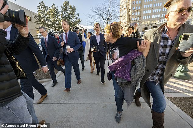 Chrystina Page, right, holds Heather De Wolf back as she yells at Jon Hallford, left, as he leaves with his lawyers after a preliminary hearing, Thursday, Feb. 8, 2024