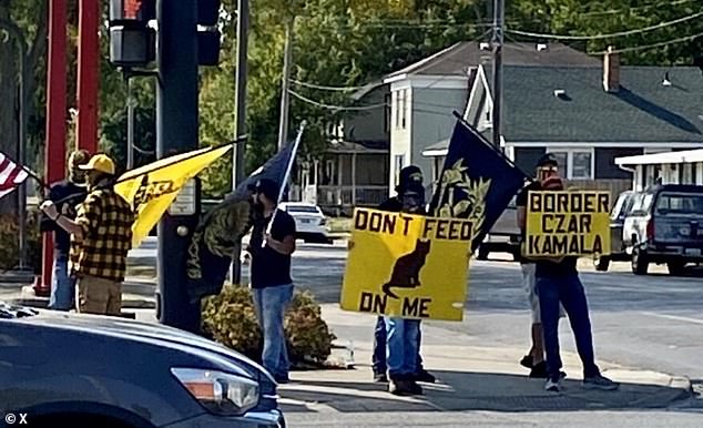 Members of the Proud Boys carried flags and placards