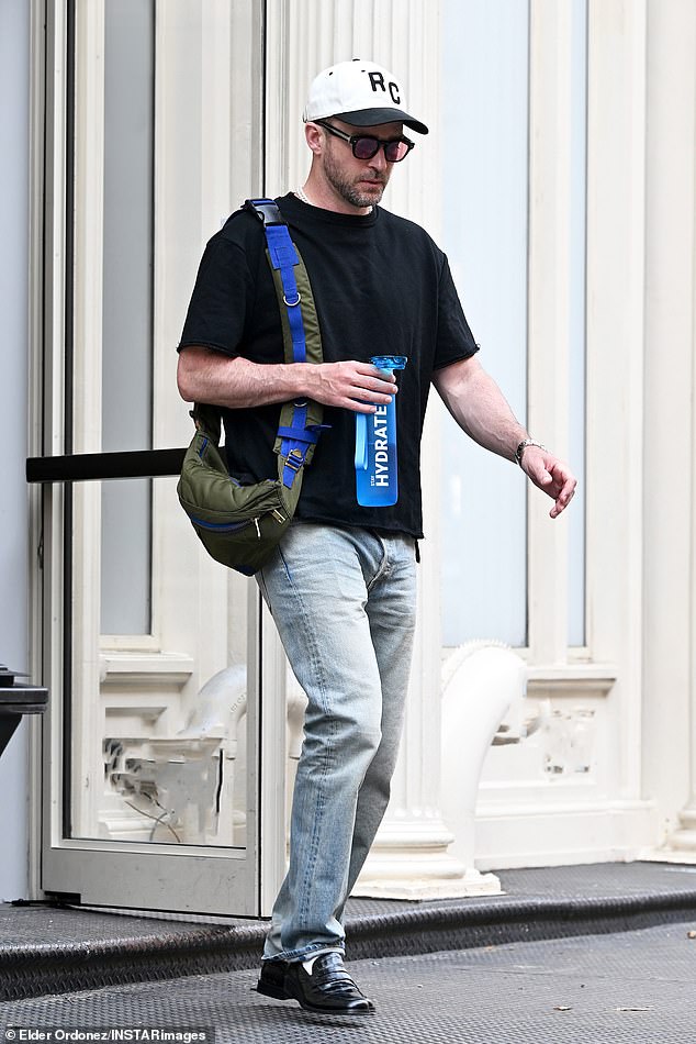 With his bag over his shoulder, the bearded pop star stepped out carrying a striking blue 'Hydrated' water bottle