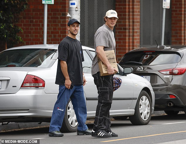 He was seen with his football friends Charlie Curnow (right) and Nick Daicos (left)