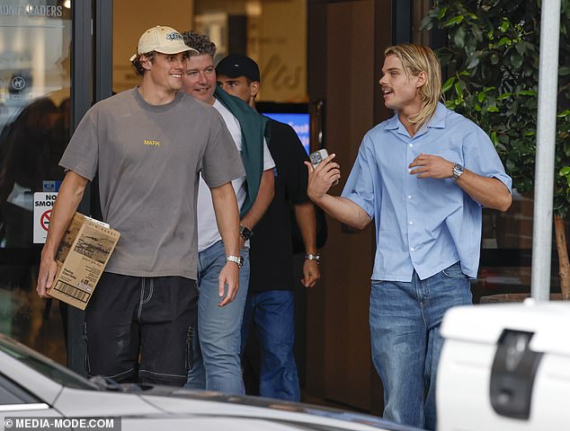 Wearing a light blue short-sleeved shirt, the midfielder chatted to Curnow, who was carrying a wine crate full of cans of Barry's shochu vodka soda.