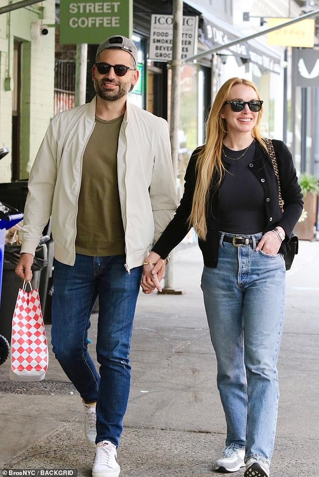 The 38-year-old Parent Trap star looked in love as she walked through SoHo in a black twinset featuring a cardigan over a matching short-sleeved sweater and jeans