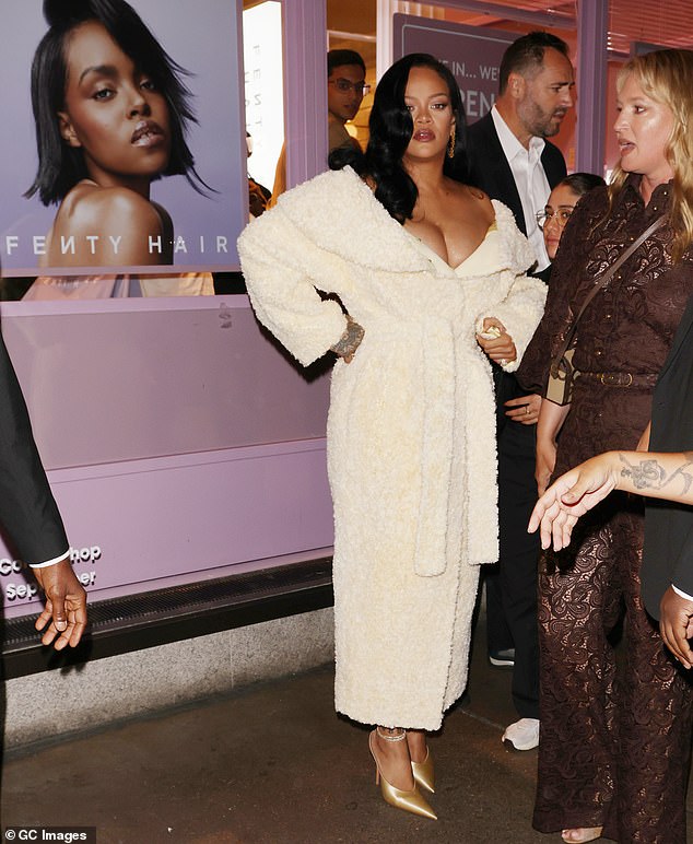 Rihanna posed in the window of Selfridges where her Fenty Hair line was on display