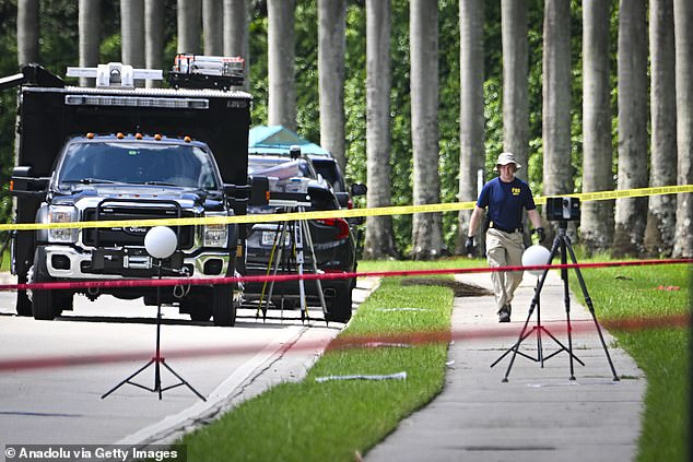 Police personnel investigate the area around Trump International Golf Club