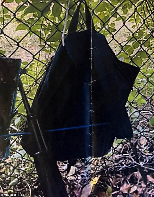 Police photos show explosions hanging from a fence above a gun leaning against it