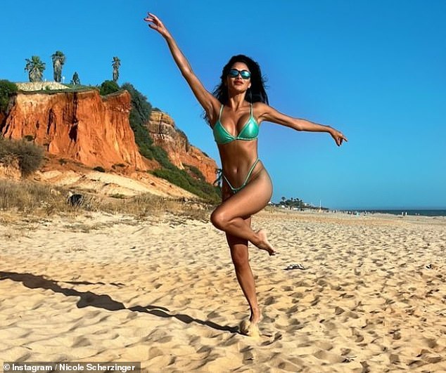 Nicole's photos showed her playfully dancing on the beach as she soaked up the sun in her revealing two-piece dress.