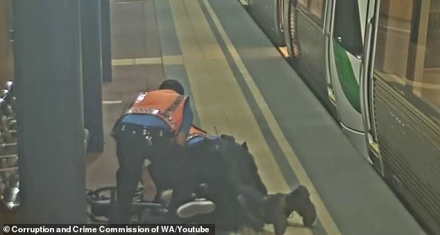 Two Perth transit officers are seen tackling the passenger on the ground