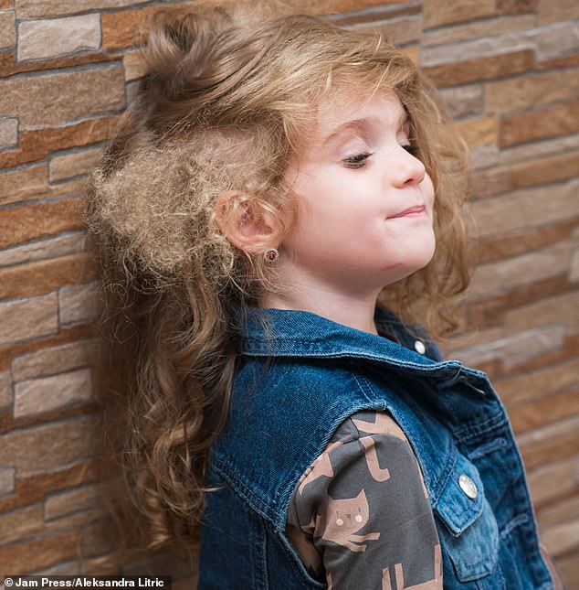 Sofija, now three years old, seemed to have mostly straight hair - but only on one side. The other side was covered in a mix of big loose curls and tight afro curls