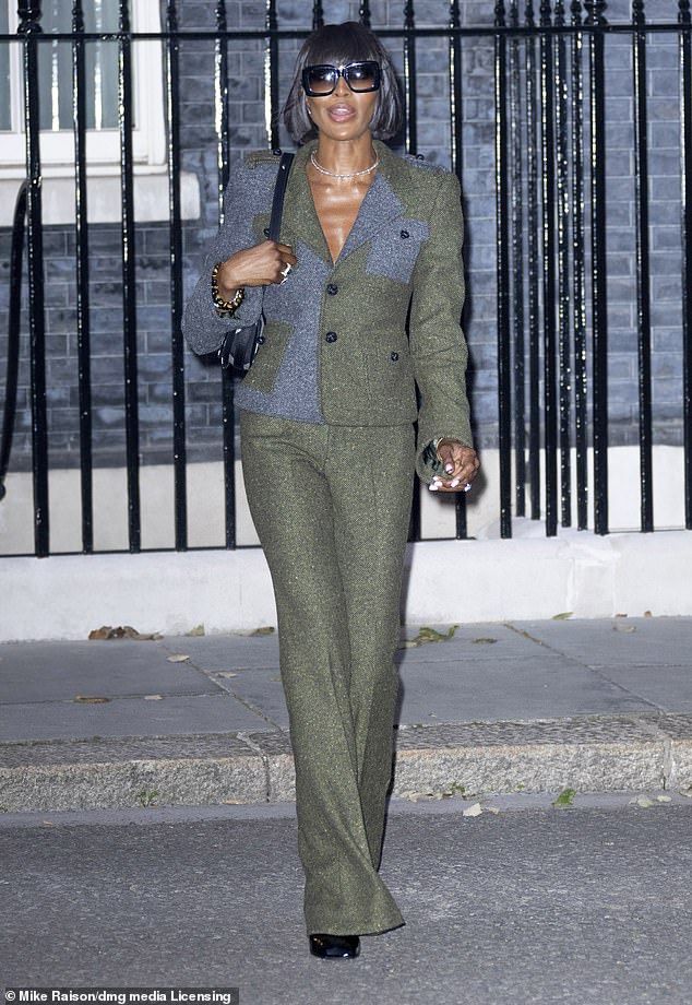 Earlier in the day, Naomi dressed to impress in a tweed green suit as she attended a reception at Downing Street during London Fashion Week