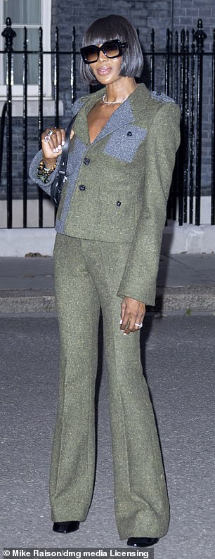 She showed off her stunning figure in the fitted jacket which she paired with matching flared trousers