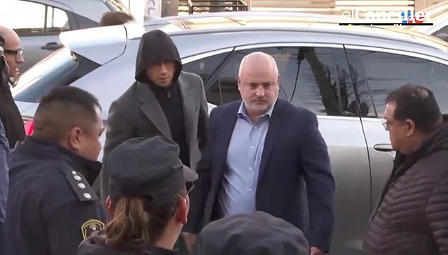 Argentine footballer Gonzalo Montiel is seen with his lawyer as he arrives at the Public Prosecutor's Office in the Buenos Aires city of La Matanza on Tuesday morning for a psychiatric evaluation after the athlete and a friend were formally accused of raping his former girlfriend.