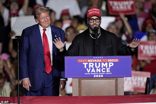 Nicky Jam speaks with former President Donald Trump during his rally in Las Vegas on September 13. The former president mislabeled the Latin singer and said 