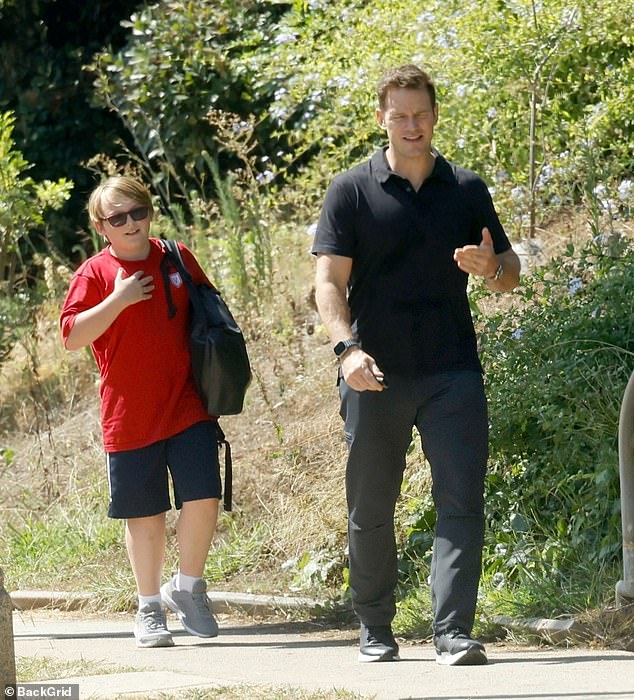 The duo looked cheerful as they walked down a path together