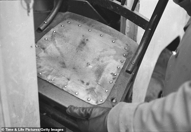 A photo shows a close-up of a chair covered in human skin found in the home of murderer and body snatcher Ed Gein in Plainfield, Wisconsin in November 1957