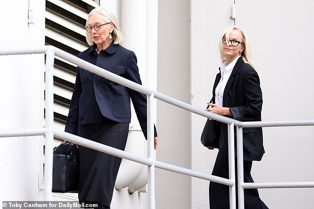 Prudence, 65, and Elizabeth walk across the gangplank to enter the building