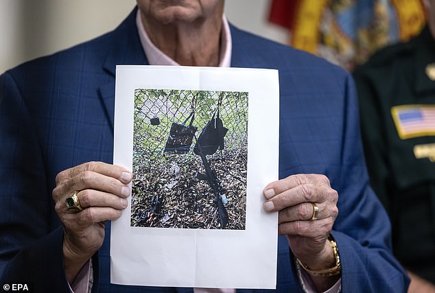 West Palm Beach Sheriff Ric Bradshaw holds up an image of Routh's backpack, purse, GoPro and AK-47-style rifle that he left behind outside Trump International Golf Club on Sunday as he fled the scene as the Secret Service opened fire