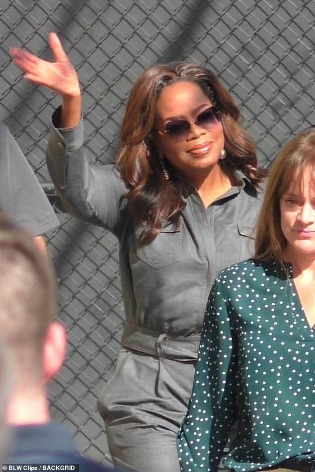 She accessorized with silver earrings and designer sunglasses