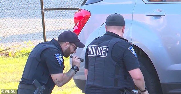 White's other daughter, six, said at the time that her mother was driving faster than normal, causing her sister to get her foot stuck on the rear tire of the car. (Photo: Police examine the rear tire)